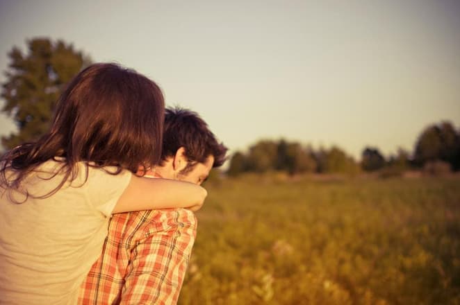 A hug in a field at golden hour